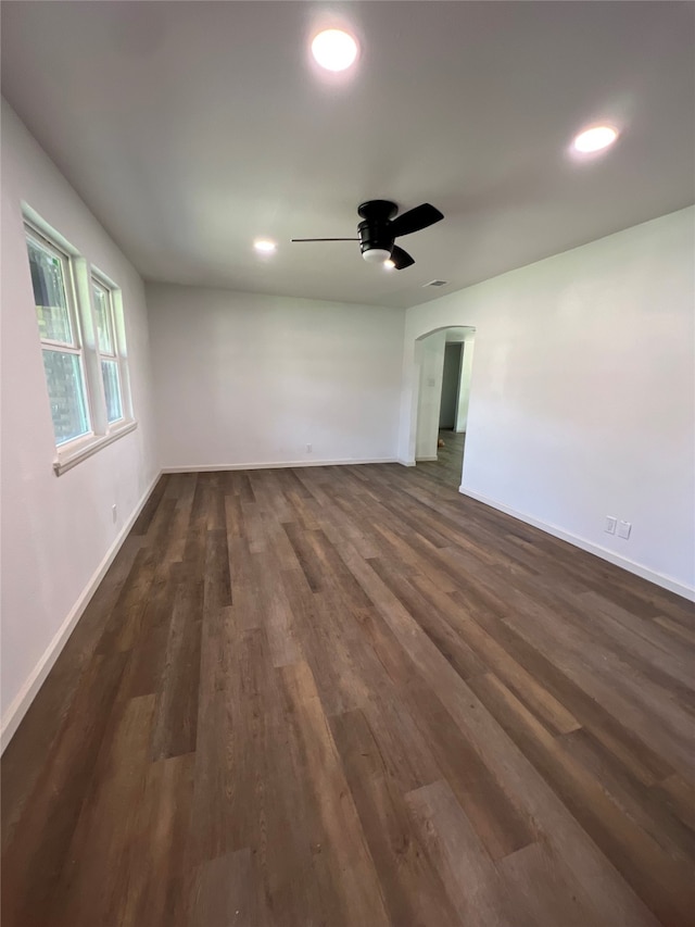 unfurnished room featuring ceiling fan and dark hardwood / wood-style flooring