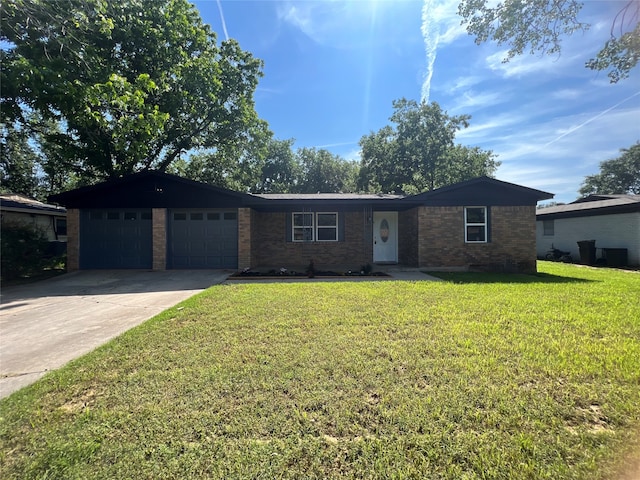 ranch-style house with a garage and a front lawn