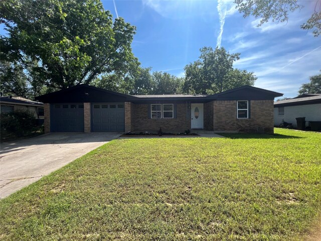 ranch-style home with a garage and a front lawn