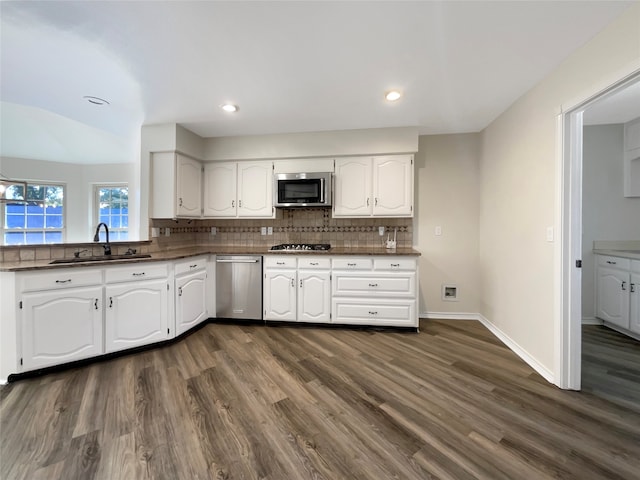 kitchen with dark wood-type flooring, white cabinetry, and stainless steel appliances