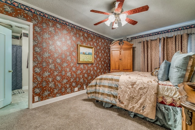 carpeted bedroom with a textured ceiling, ceiling fan, and crown molding