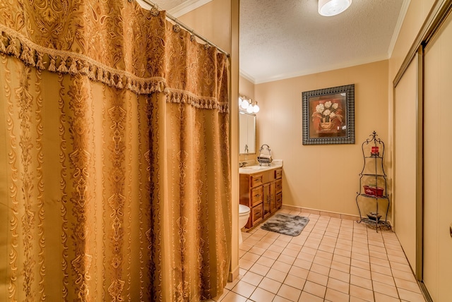 bathroom with toilet, a textured ceiling, tile patterned floors, ornamental molding, and vanity