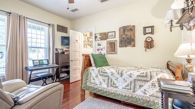 bedroom featuring ceiling fan and dark wood-type flooring