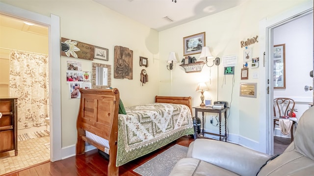 bedroom featuring hardwood / wood-style floors and connected bathroom