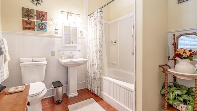 full bathroom with wood-type flooring, sink, toilet, shower / bath combo with shower curtain, and radiator heating unit