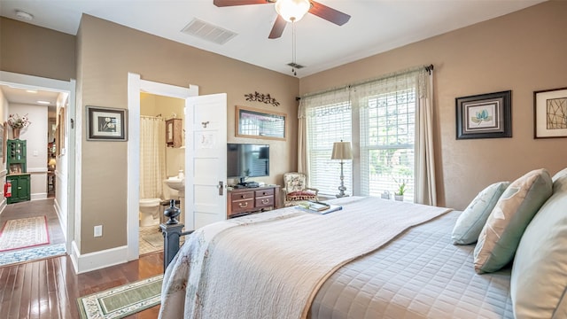 bedroom featuring hardwood / wood-style flooring, ensuite bath, and ceiling fan