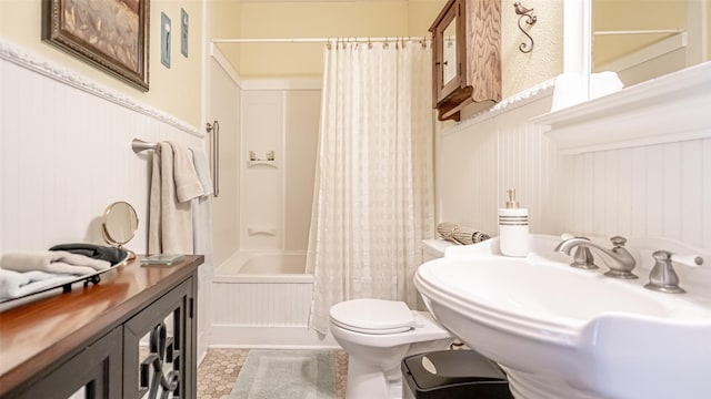 full bathroom with toilet, tile patterned flooring, shower / tub combo with curtain, and sink