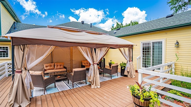 wooden terrace featuring outdoor lounge area and a gazebo