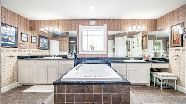 bathroom with tile patterned flooring, vanity, and a textured ceiling