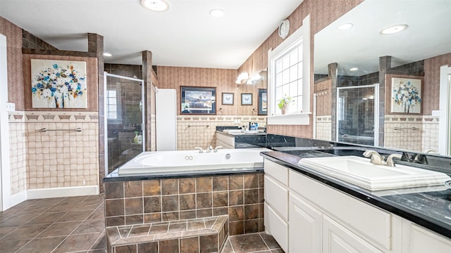 bathroom featuring vanity, tile patterned floors, tile walls, and independent shower and bath