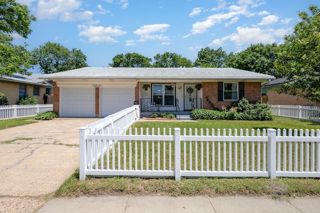 ranch-style house with a garage and covered porch