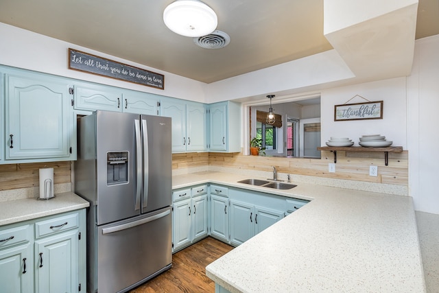 kitchen featuring hardwood / wood-style flooring, backsplash, stainless steel refrigerator with ice dispenser, sink, and blue cabinets