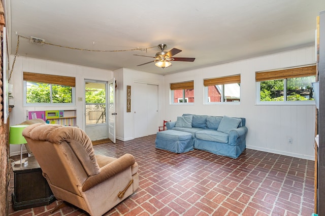 living room with plenty of natural light and ceiling fan