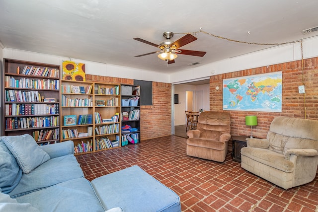 living room featuring brick wall and ceiling fan