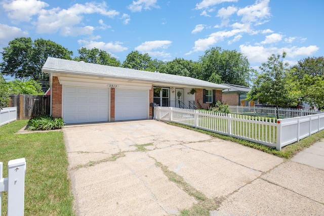 ranch-style home featuring a garage and a front lawn