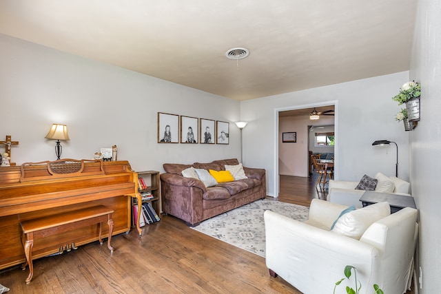 living room featuring hardwood / wood-style flooring and ceiling fan