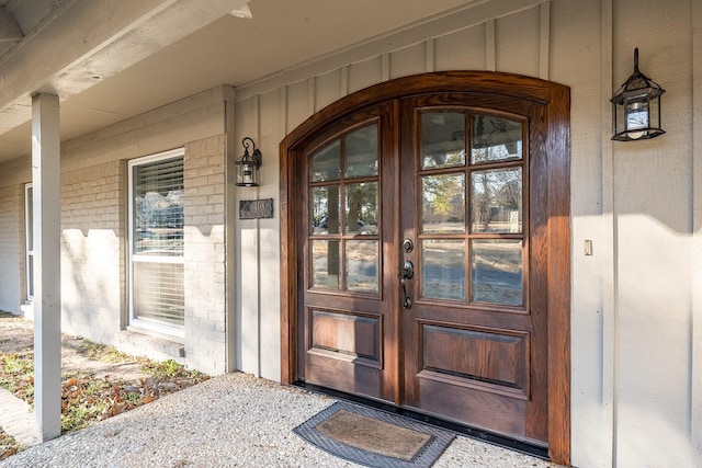 entrance to property with french doors and a porch