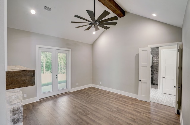 empty room with beamed ceiling, hardwood / wood-style floors, ceiling fan, and french doors