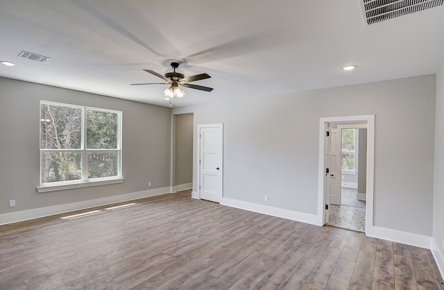 unfurnished room with hardwood / wood-style flooring and ceiling fan