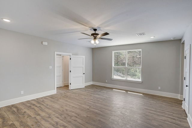 unfurnished room with hardwood / wood-style floors and ceiling fan