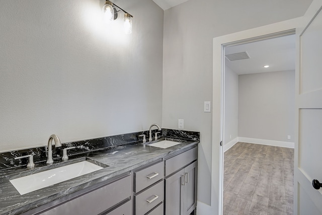 bathroom featuring hardwood / wood-style floors and double vanity