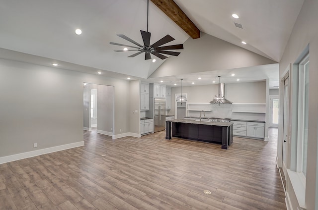 interior space featuring high vaulted ceiling, ceiling fan, light hardwood / wood-style flooring, and beamed ceiling