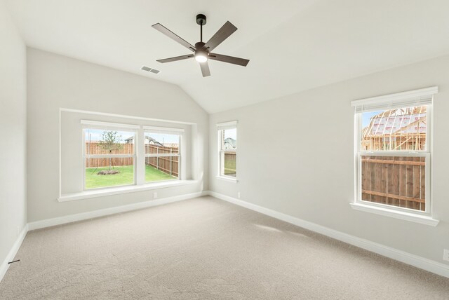 carpeted empty room featuring ceiling fan and vaulted ceiling