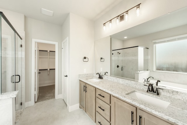 bathroom featuring tile patterned floors, shower with separate bathtub, and vanity