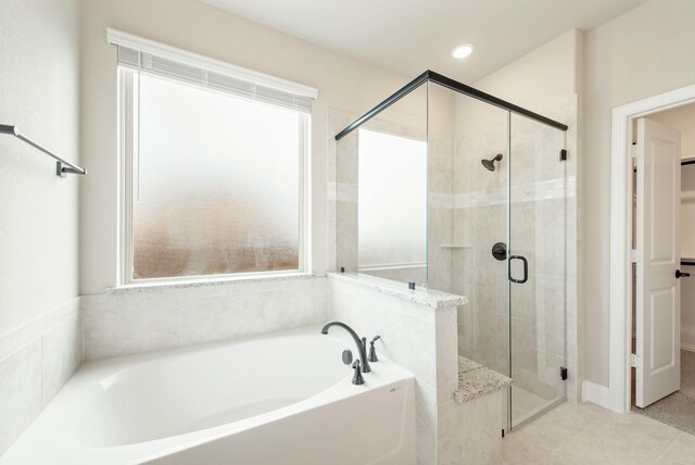 bathroom with plenty of natural light, separate shower and tub, and tile patterned flooring