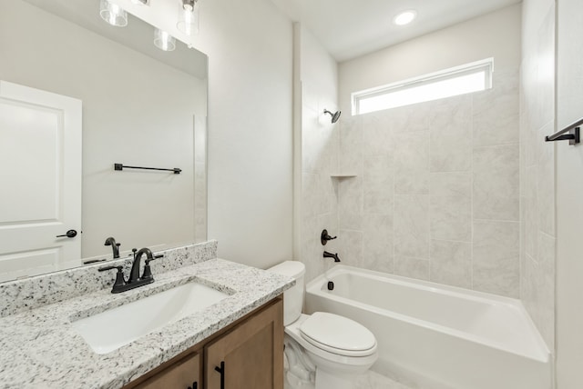 full bathroom featuring toilet, tiled shower / bath combo, and vanity