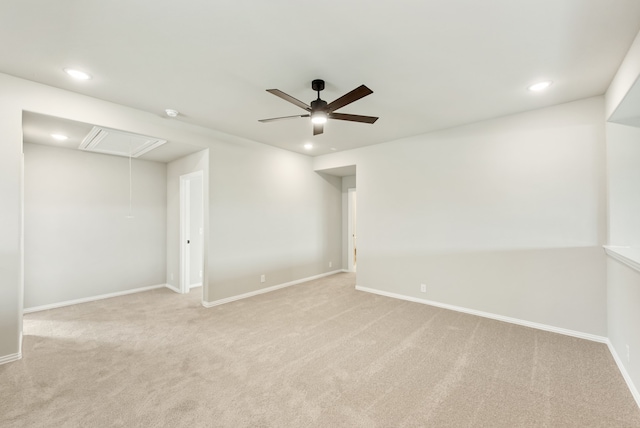 spare room featuring light carpet and ceiling fan