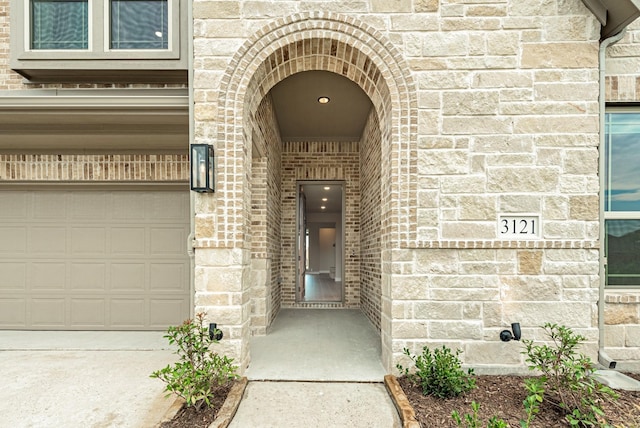 doorway to property with stone siding and brick siding