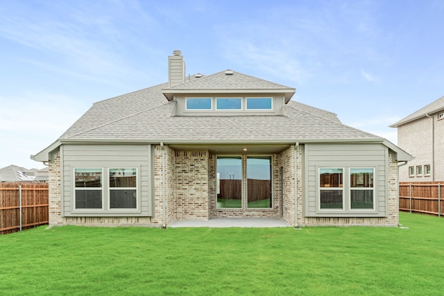 rear view of house featuring a lawn