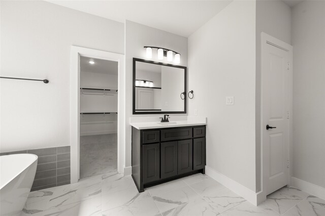 bathroom featuring vanity and a washtub