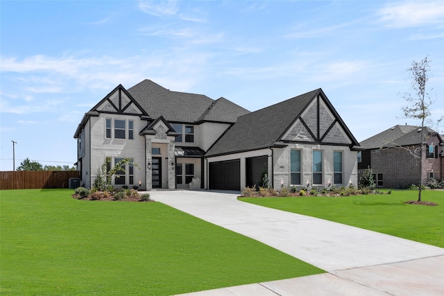 english style home featuring a garage, central AC unit, and a front yard