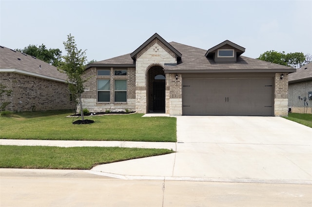 view of front of house with a garage and a front lawn