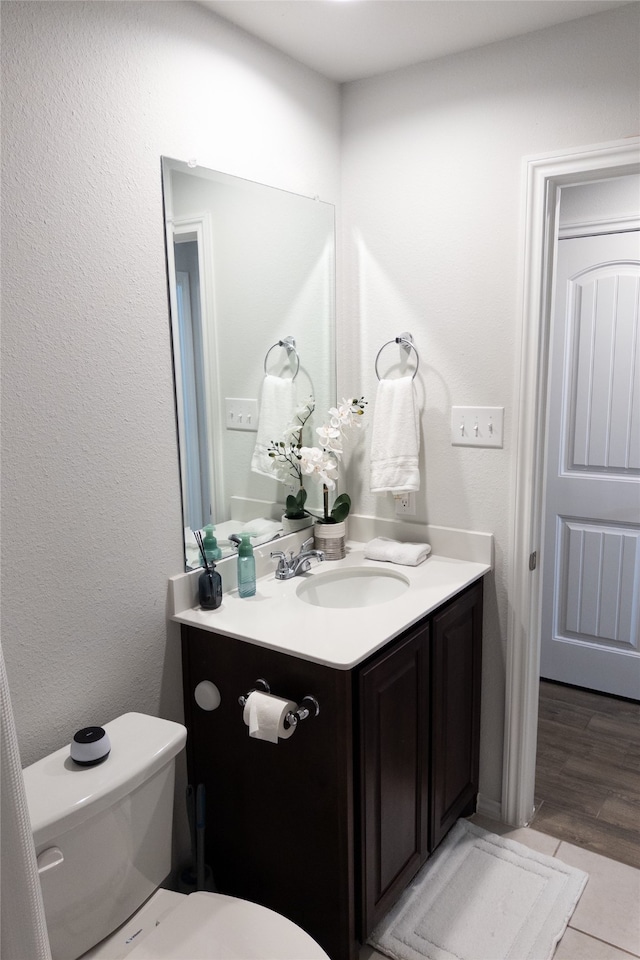 bathroom featuring vanity and toilet