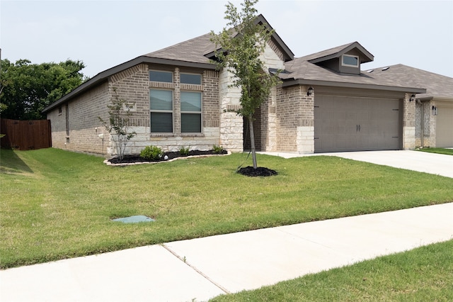 view of front of home with a garage and a front lawn