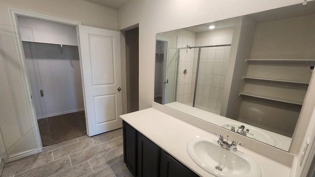 bathroom featuring vanity and an enclosed shower