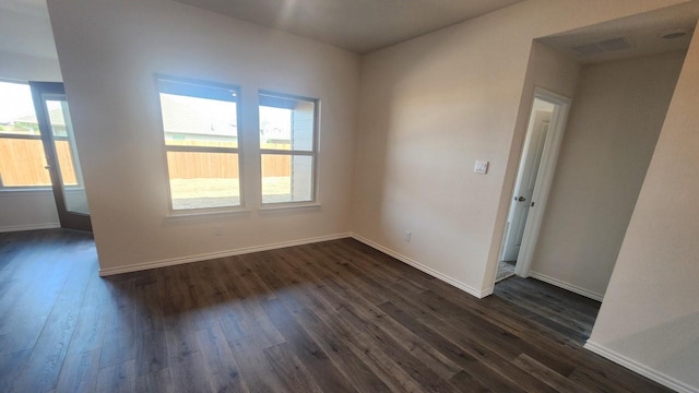 unfurnished room featuring dark hardwood / wood-style flooring