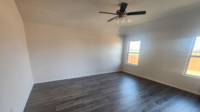 spare room with ceiling fan and dark hardwood / wood-style floors