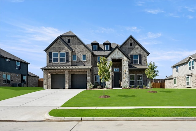 view of front of home featuring central AC, a front yard, and a garage