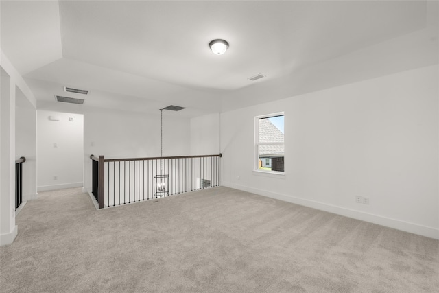 unfurnished room featuring light colored carpet