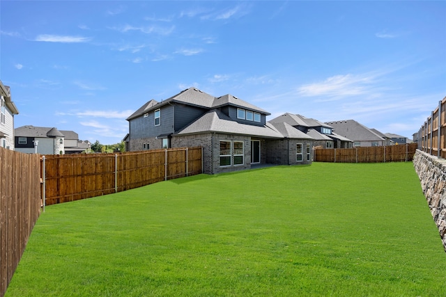 back of house with a yard