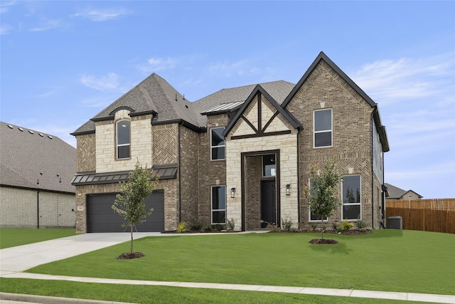 view of front of property featuring a garage and a front lawn