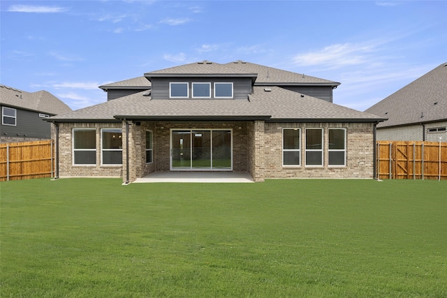 back of house with a lawn and a patio area