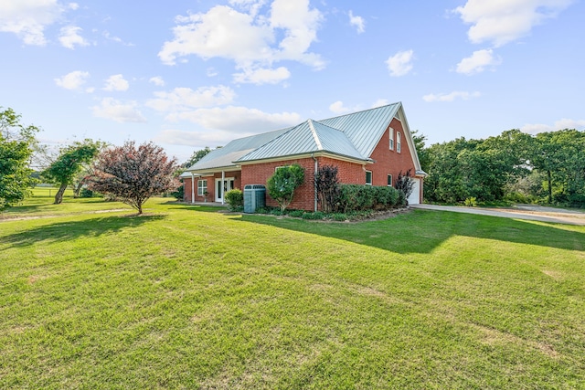 view of front of home featuring a front yard and central AC