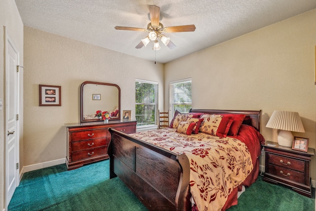 bedroom with a textured ceiling, dark colored carpet, and ceiling fan