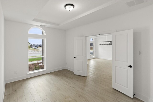 1710 Seagrove Ln, Cedar Hill, TX 75104 - empty room featuring a tray ceiling, light wood-type flooring, and baseboards