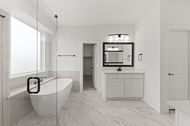 bathroom featuring separate shower and tub and vanity